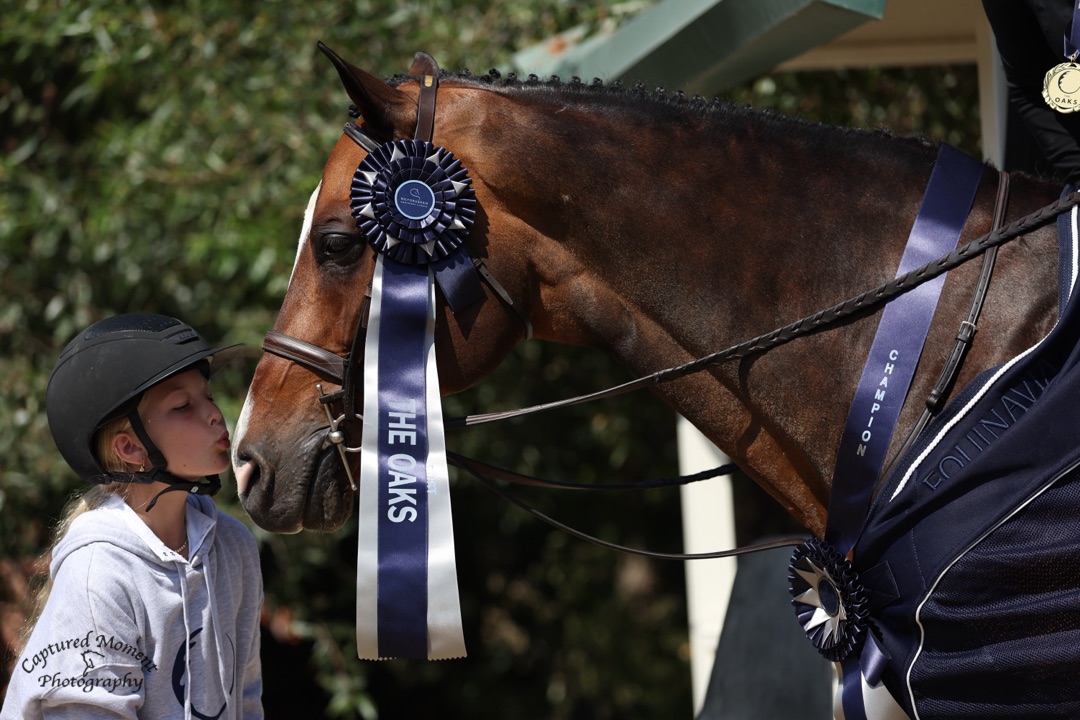 Sophie Cohen and Christopher Robin Kisses for the Low Adult Hunter Champion 2026 Oaks Photo by Captured Moment